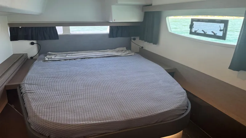  Yacht Photos Pics 2019 Fountaine Pajot Lucia 40 cabin with a cozy bed and ocean view.