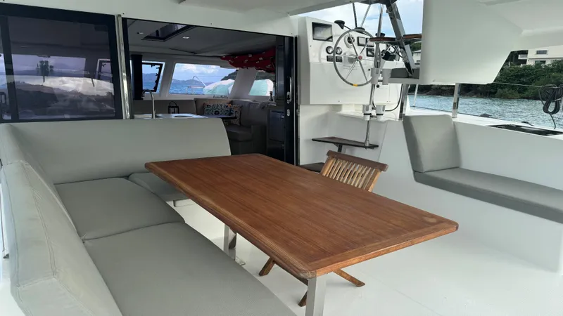  Yacht Photos Pics 2019 Fountaine Pajot Lucia 40 yacht interior with dining area and helm station.