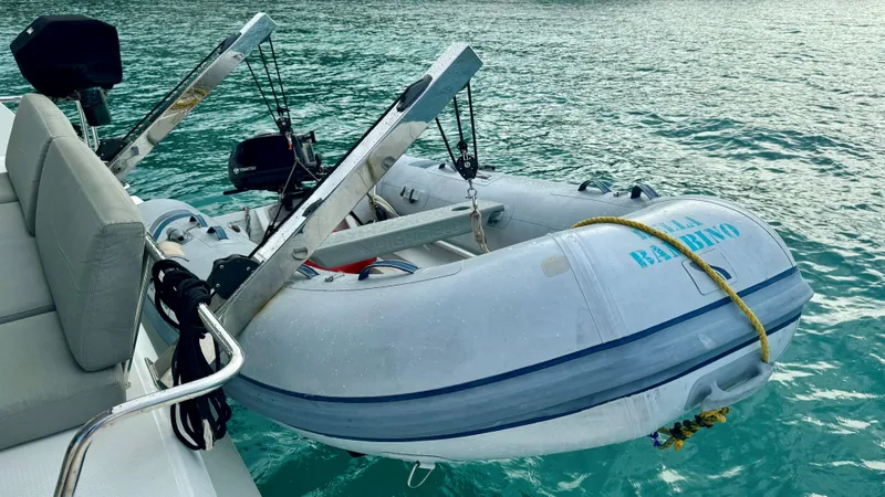  Yacht Photos Pics Inflatable dinghy attached to a 2019 Fountaine Pajot Lucia 40 catamaran on calm water.