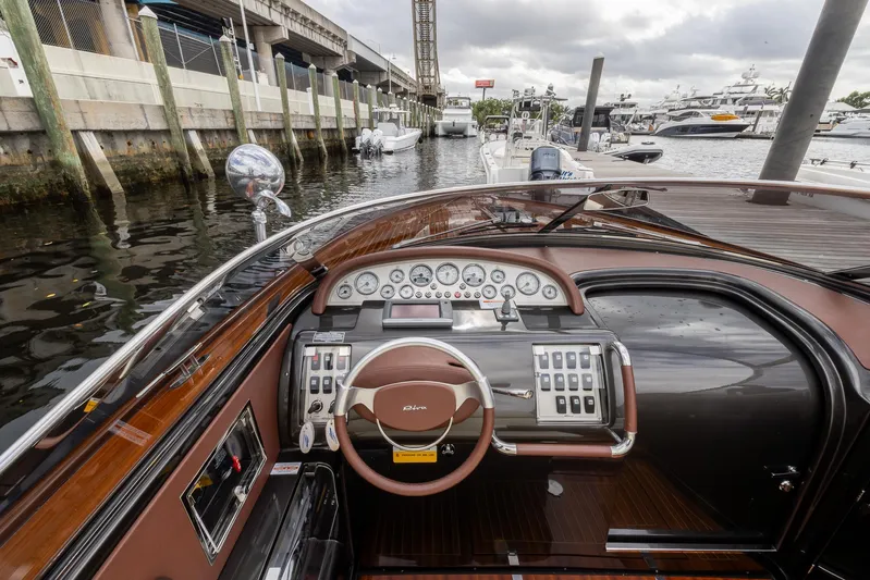  Yacht Photos Pics 2013 Riva Aquariva Super boat dashboard with steering wheel and controls at marina.
