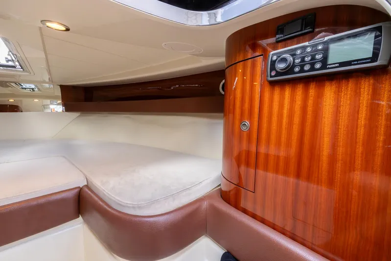  Yacht Photos Pics Luxurious 2013 Riva Aquariva Super cabin interior with wood paneling and modern audio system.