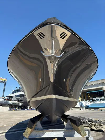  Yacht Photos Pics 2013 Riva Aquariva Super luxury boat on display under clear blue sky.