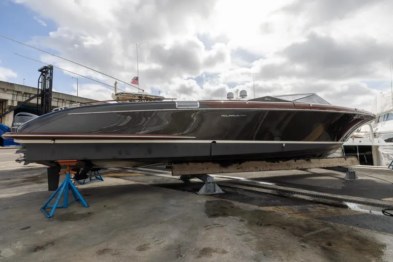  Yacht Photos Pics 2013 Riva Aquariva Super luxury boat on dry dock under cloudy sky.