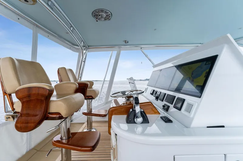 How Bout It Yacht Photos Pics Helm of 2017 Custom Carolina 43 Cinco Boatworks Express with leather seats and navigation controls.