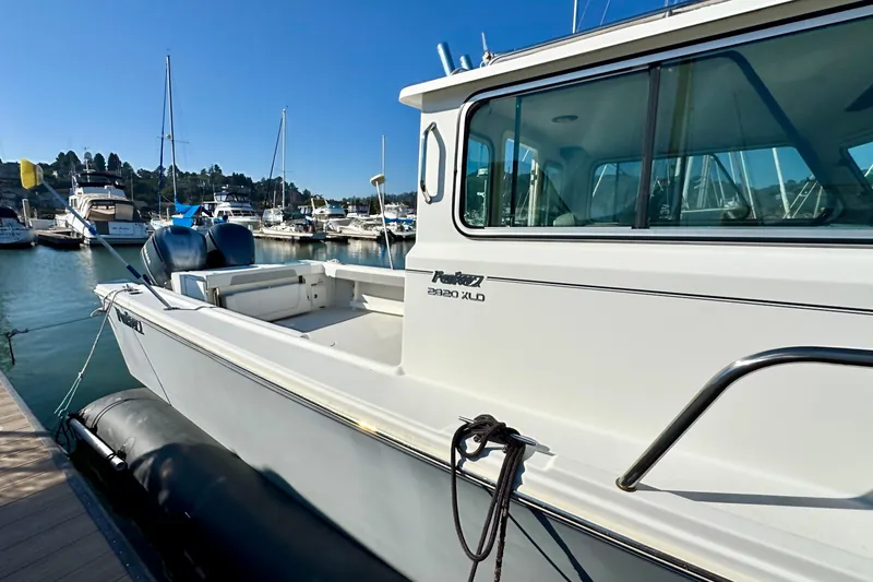  Yacht Photos Pics 2021 Parker 2820 XLD Sport Cabin boat docked in a marina under clear blue skies.