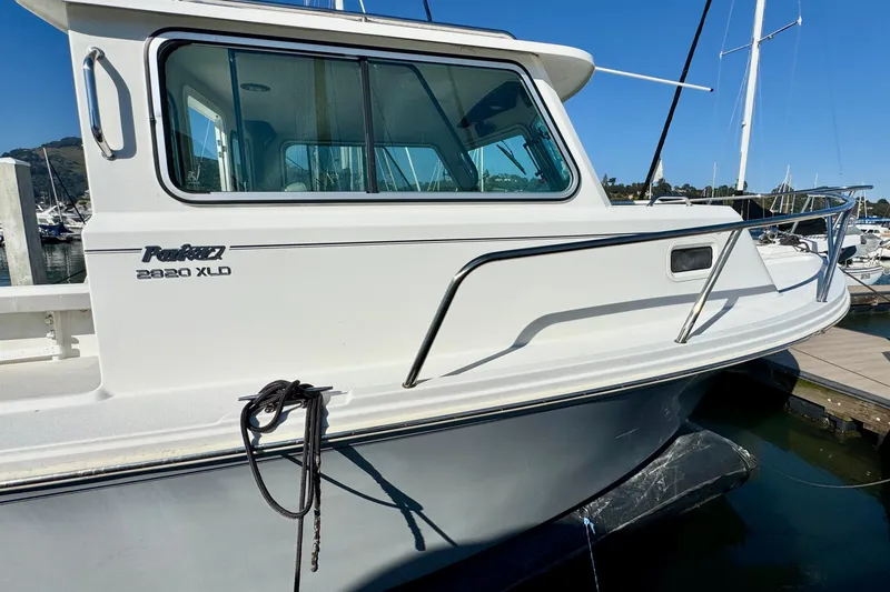  Yacht Photos Pics 2021 Parker 2820 XLD Sport Cabin boat docked at marina, side view.