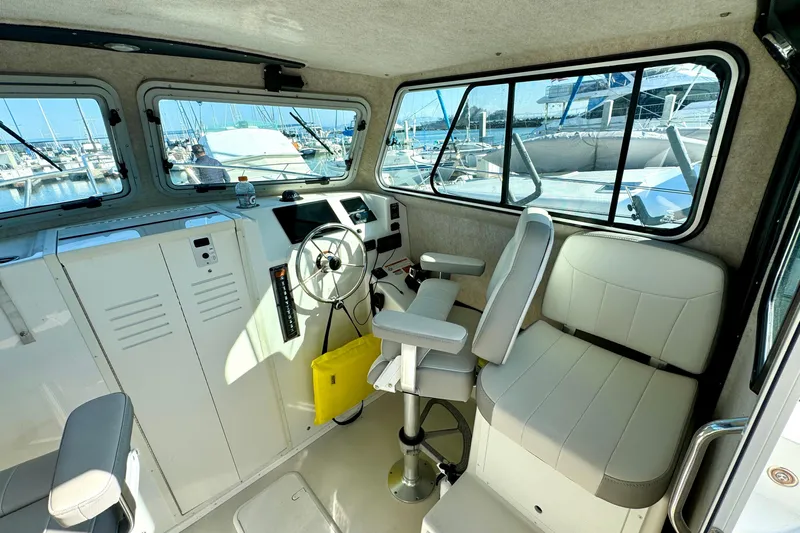  Yacht Photos Pics 2021 Parker 2820 XLD Sport Cabin interior with helm, seating, and marina view.