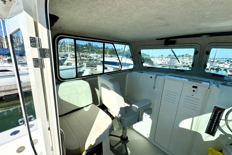  Yacht Photos Pics 2021 Parker 2820 XLD Sport Cabin interior with marina view through large windows.