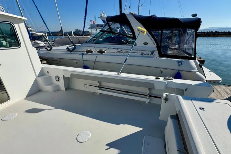  Yacht Photos Pics 2021 Parker 2820 XLD Sport Cabin docked beside another boat in a marina.