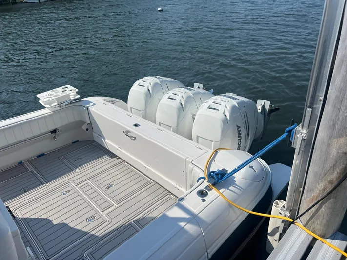  Yacht Photos Pics 2019 Intrepid 407 Cuddy boat with triple outboard engines docked.