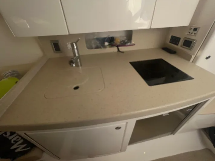  Yacht Photos Pics 2019 Intrepid 407 Cuddy boat kitchen with sink and stovetop.