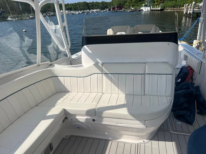  Yacht Photos Pics 2019 Intrepid 407 Cuddy boat with white seating and scenic marina background.
