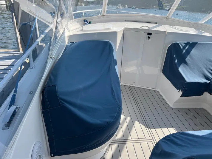  Yacht Photos Pics 2019 Intrepid 407 Cuddy boat interior with blue seat covers and white deck.