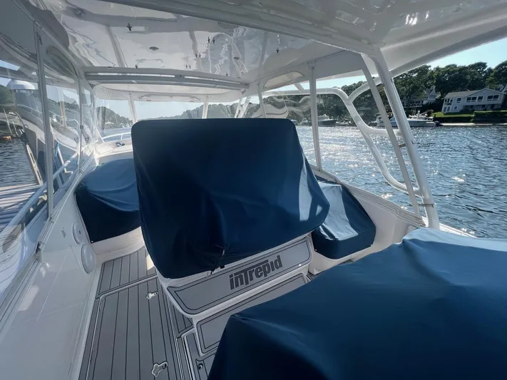  Yacht Photos Pics 2019 Intrepid 407 Cuddy boat interior with blue seat covers on a sunny day.