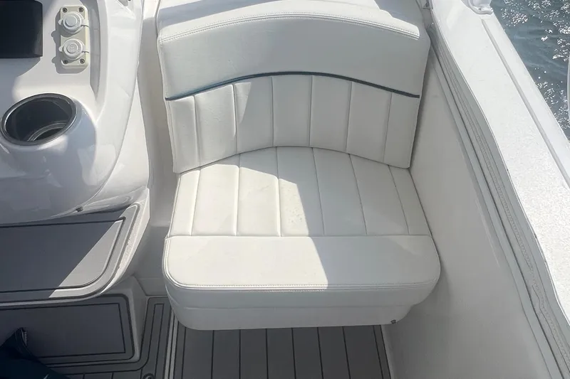  Yacht Photos Pics 2019 Intrepid 407 Cuddy boat with white cushioned seating and cup holder.