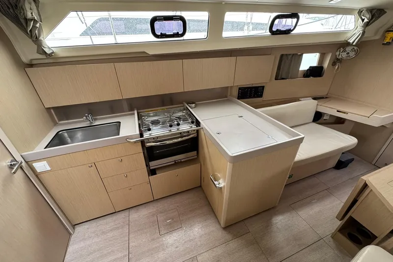 Nafsika Yacht Photos Pics Modern kitchen interior of 2020 Beneteau Oceanis 41.1 yacht with stove and seating area.