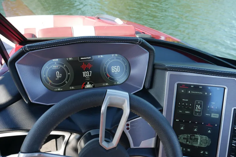  Yacht Photos Pics 2022 MasterCraft X22 dashboard with digital displays and control panel on water.