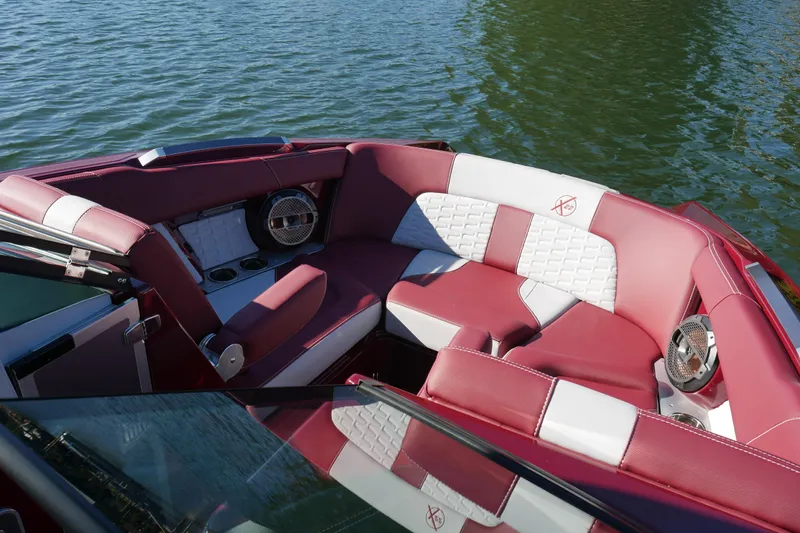  Yacht Photos Pics 2022 MasterCraft X22 boat interior with red and white seating on water.
