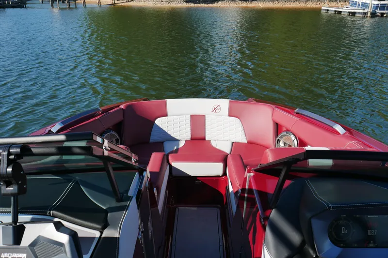  Yacht Photos Pics 2022 MasterCraft X22 boat interior with red and white seating on a lake.