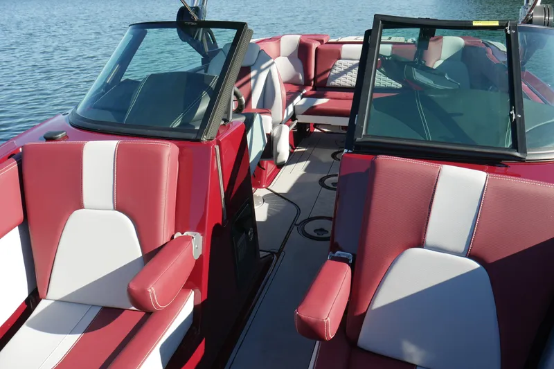 Yacht Photos Pics 2022 MasterCraft X22 boat interior with red and white seating on a sunny day.
