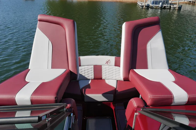  Yacht Photos Pics 2022 MasterCraft X22 boat interior with red and white seating on a lake.