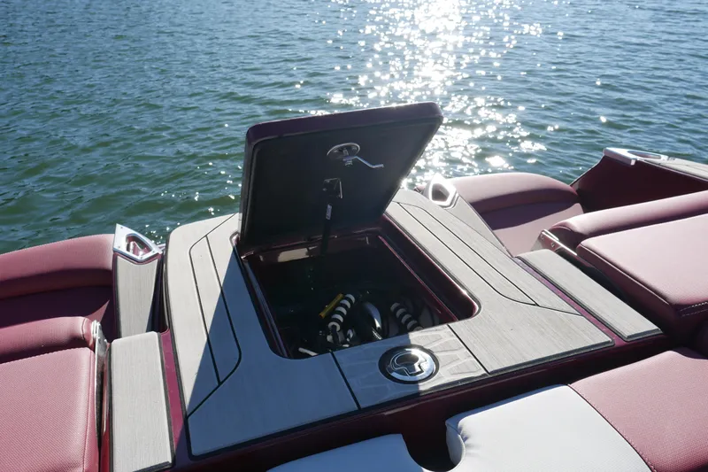  Yacht Photos Pics 2022 MasterCraft X22 boat with open storage compartment on a sunny lake.