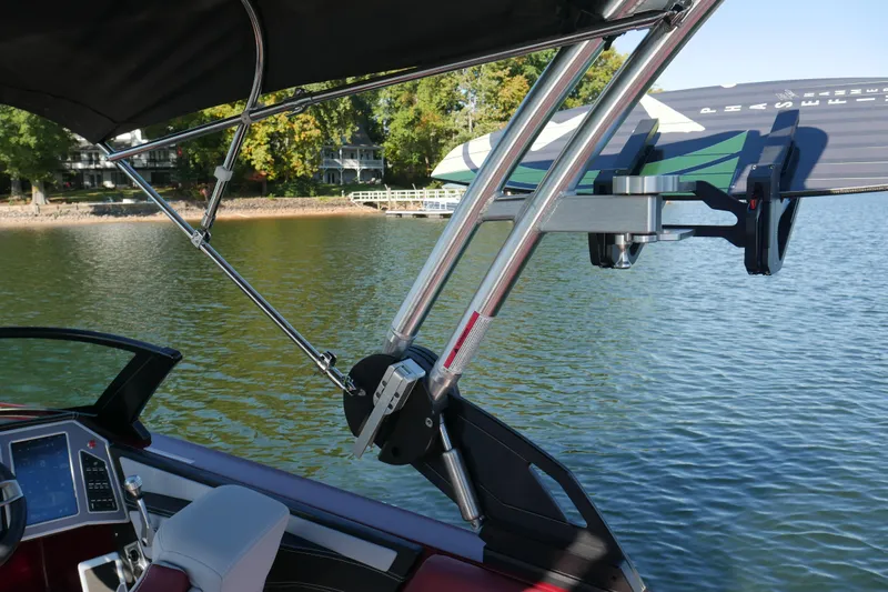  Yacht Photos Pics 2022 MasterCraft X22 boat with wakeboard rack on a calm lake.