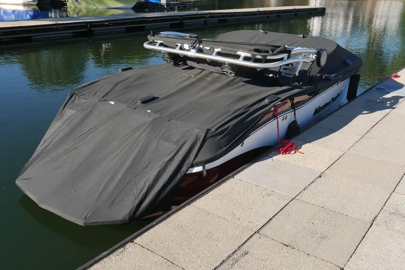  Yacht Photos Pics 2022 MasterCraft X22 boat covered at dockside, ready for storage.