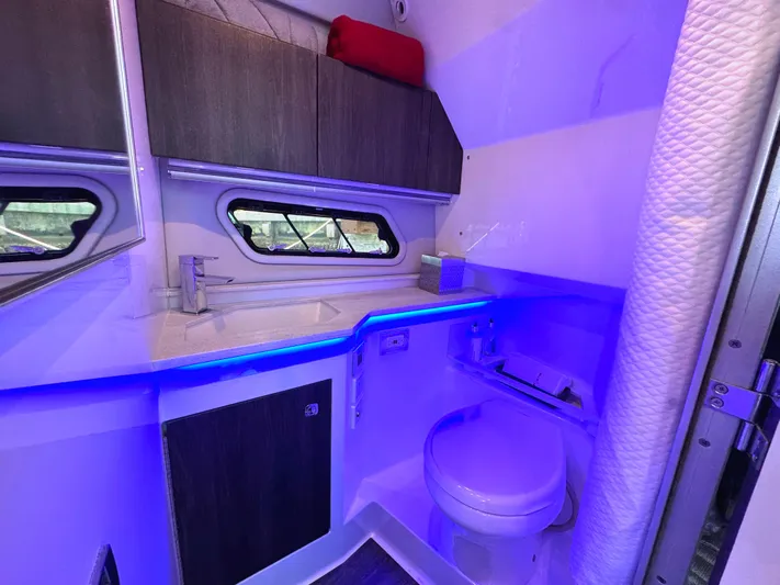 Happy2gether Yacht Photos Pics 2021 Formula 380 Super Sport Crossover OB bathroom with modern fixtures and blue ambient lighting.