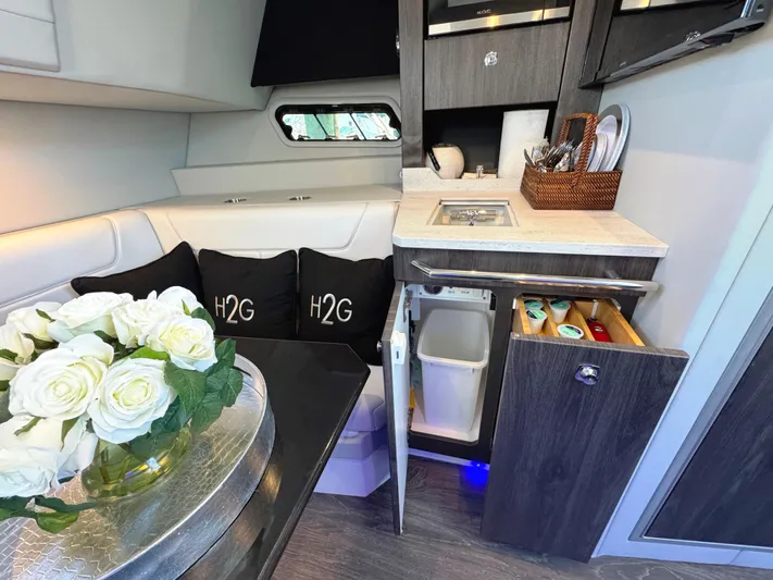 Happy2gether Yacht Photos Pics Luxurious interior of 2021 Formula 380 Super Sport Crossover OB with elegant seating and kitchenette.