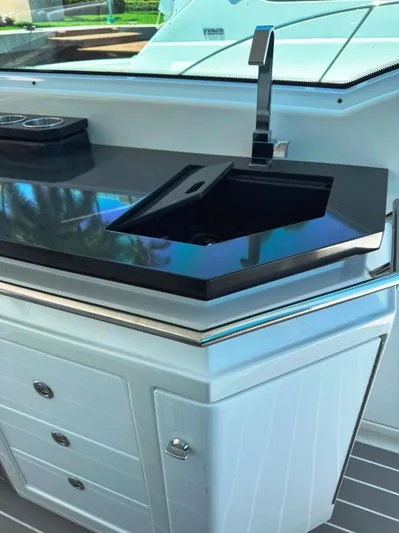 Happy2gether Yacht Photos Pics 2021 Formula 380 Super Sport Crossover OB boat kitchen with sleek black countertop and modern sink.