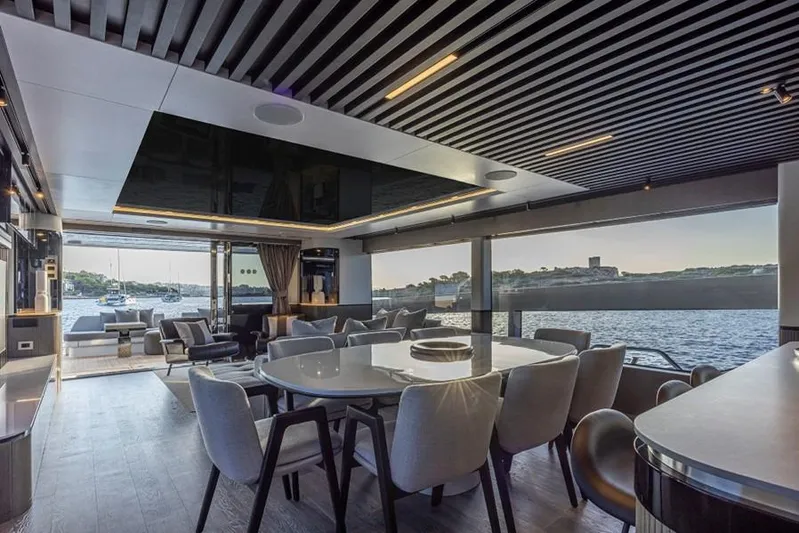 Pearly Spencer Yacht Photos Pics Luxurious interior of 2024 Pearl 82 yacht with elegant dining area and scenic ocean view.