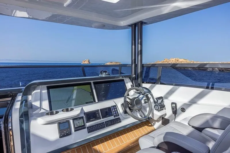 Pearly Spencer Yacht Photos Pics Luxurious helm of 2024 Pearl 82 yacht with advanced navigation systems and ocean view.