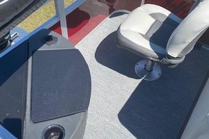 2026 Sun Tracker Bass Buggy 18 DLX interior with seating and carpeted flooring.