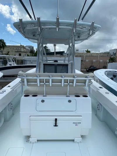 Saborr Yacht Photos Pics 2017 Contender 35 Tournament boat with center console and rod holders, docked under cloudy skies.