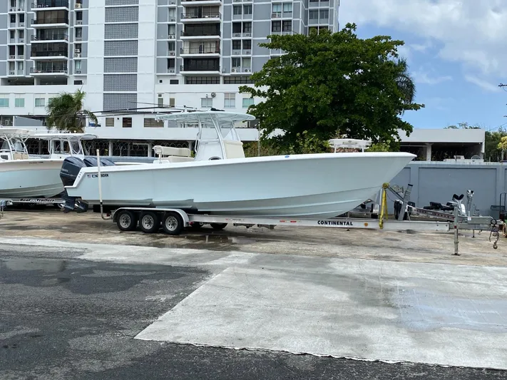 Saborr Yacht Photos Pics 2017 Contender 35 Tournament boat on trailer, parked near high-rise buildings.