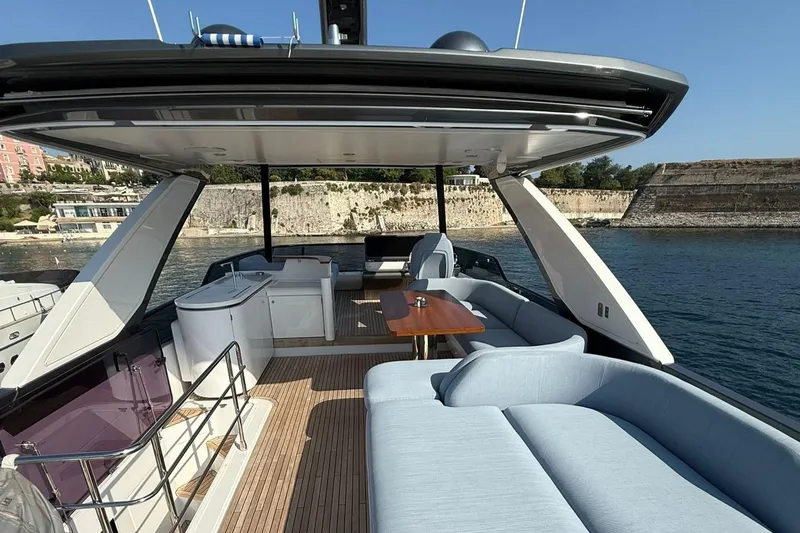  Yacht Photos Pics Luxurious 2022 Azimut Fly 68 yacht deck with elegant seating and scenic waterfront view.