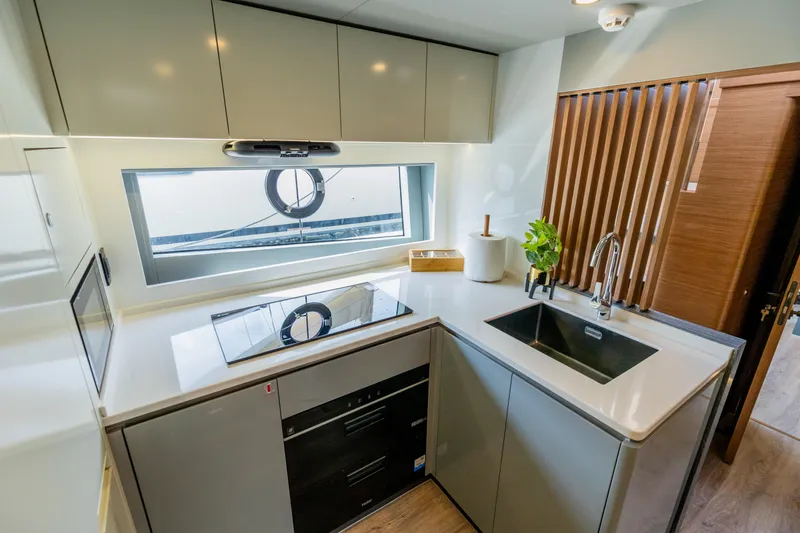  Yacht Photos Pics Modern kitchen in 2025 Skywalker X62 yacht with sleek design and appliances.