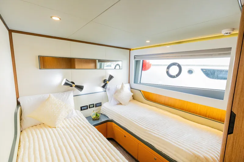  Yacht Photos Pics Luxurious Skywalker X62 yacht cabin with twin beds and modern decor, 2025 model.