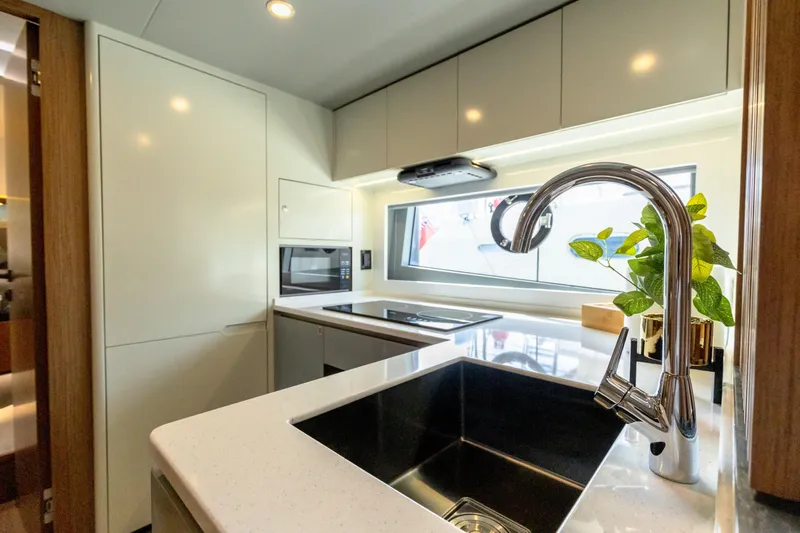  Yacht Photos Pics Modern kitchen in 2025 Skywalker X62 yacht with sleek design and stainless steel sink.