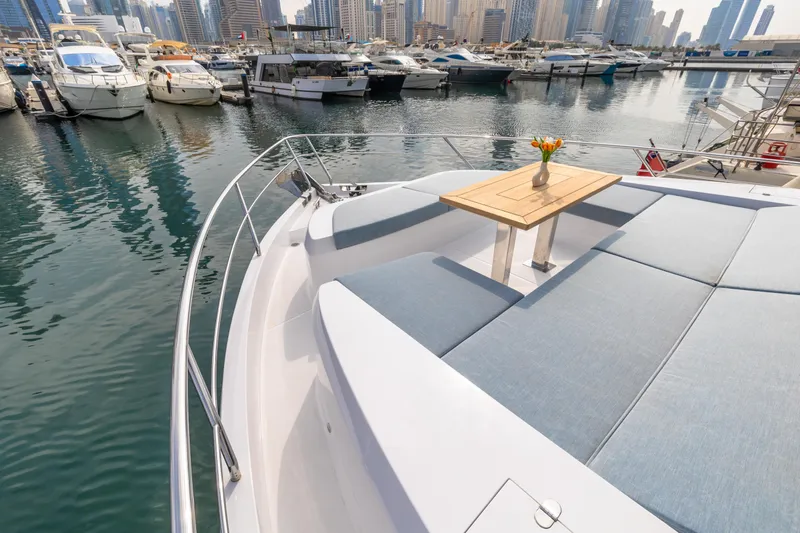  Yacht Photos Pics Luxurious Skywalker X62 yacht deck with seating, table, and marina view, 2025 model.