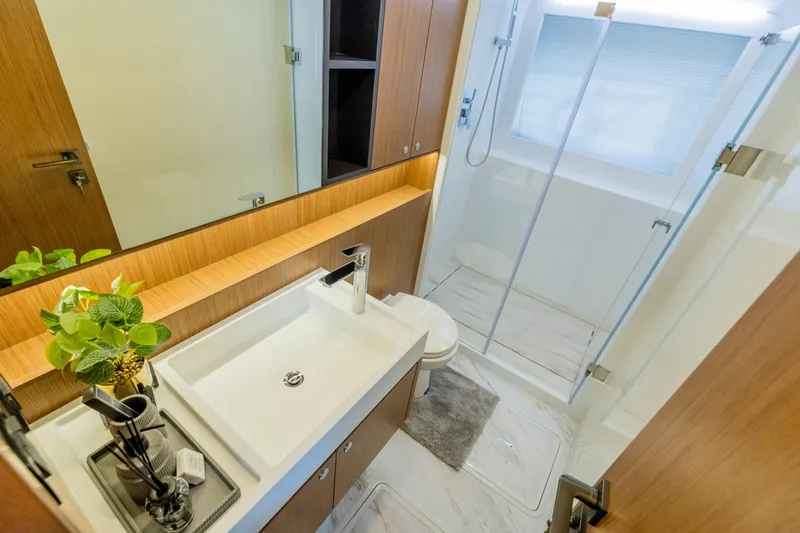 Yacht Photos Pics Modern bathroom in Skywalker X62 yacht, featuring sleek design and glass shower, 2025 model.