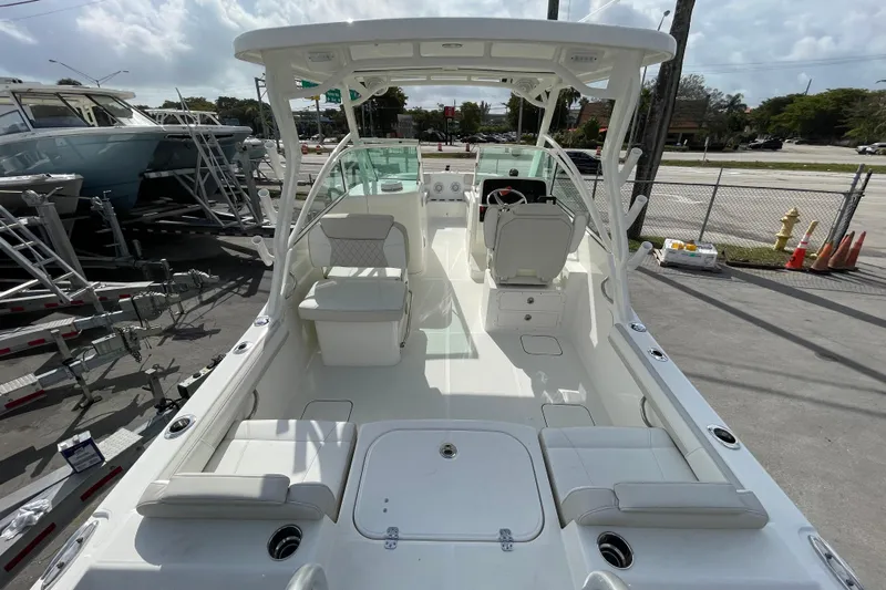 55889 230dc Sf Yacht Photos Pics 2025 World Cat 230 DC boat interior with seating and helm, parked on a trailer.