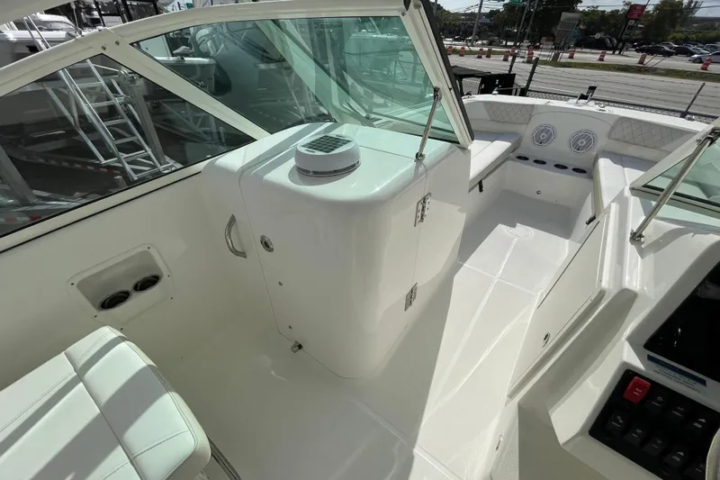 55889 230dc Sf Yacht Photos Pics 2025 World Cat 230 DC boat interior with seating and control panel.