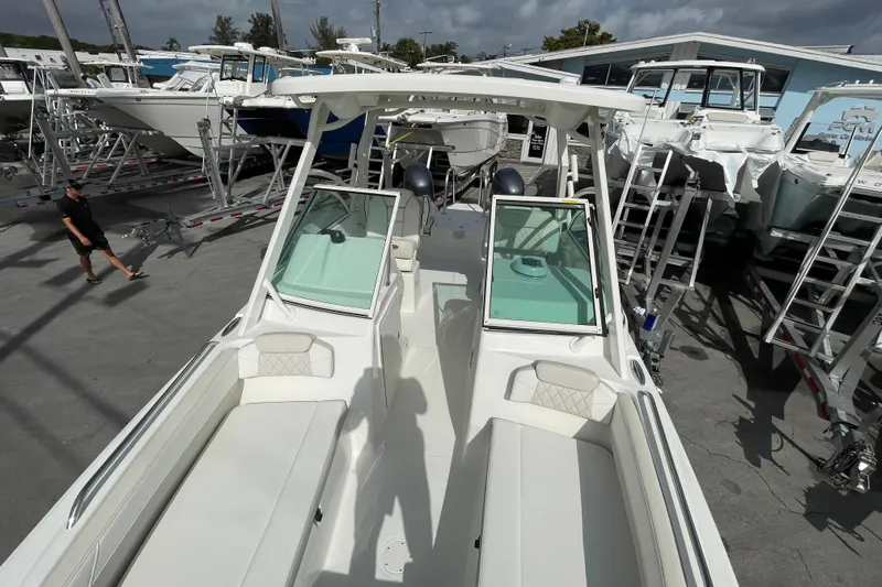 55889 230dc Sf Yacht Photos Pics 2025 World Cat 230 DC boat in a marina, surrounded by other vessels.