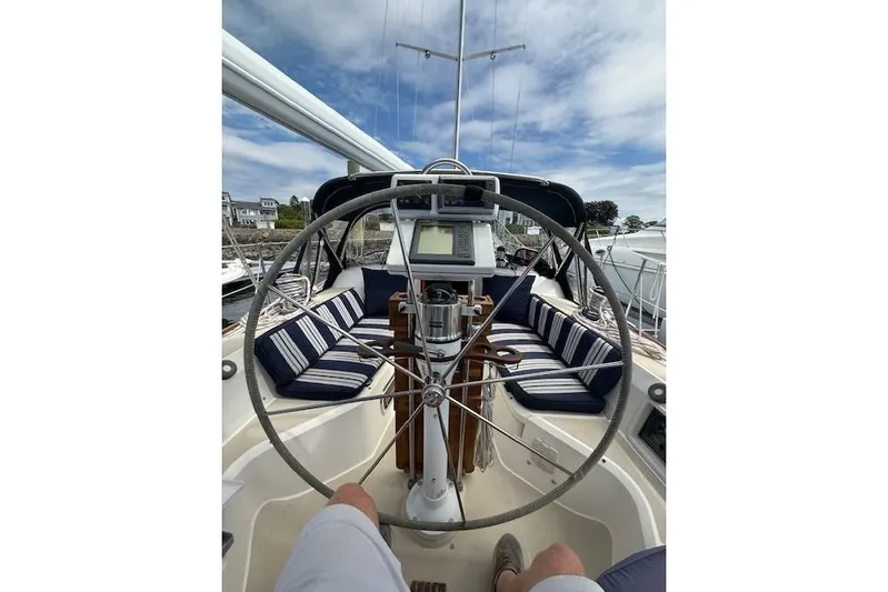 Star Yacht Photos Pics Cockpit view of 1998 Sabre 402 sailboat with striped seating and steering wheel.
