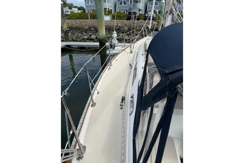 Star Yacht Photos Pics 1998 Sabre 402 sailboat docked, featuring sleek deck and blue canopy.
