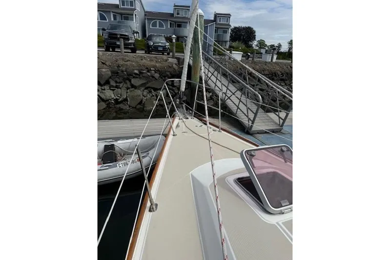 Star Yacht Photos Pics 1998 Sabre 402 sailboat docked at marina with residential backdrop.