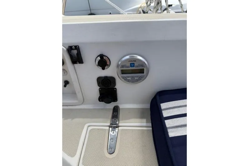 Star Yacht Photos Pics Control panel on a 1998 Sabre 402 sailboat with striped cushion nearby.