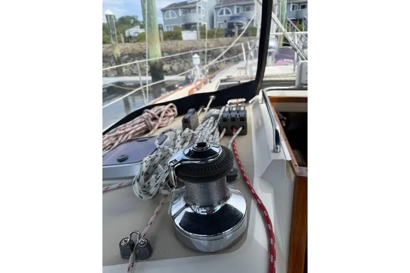 Star Yacht Photos Pics Sailboat deck with winch and ropes, Sabre 402, 1998 model, docked near waterfront homes.